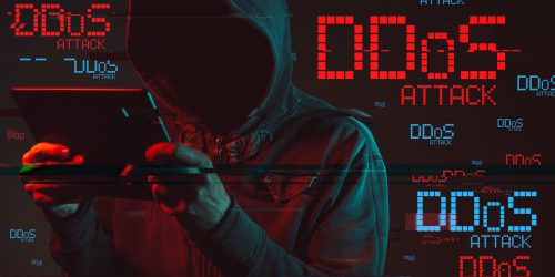 Distributed denial of service or DDoS attack concept with faceless hooded male person using tablet computer, low key red and blue lit image and digital glitch effect
